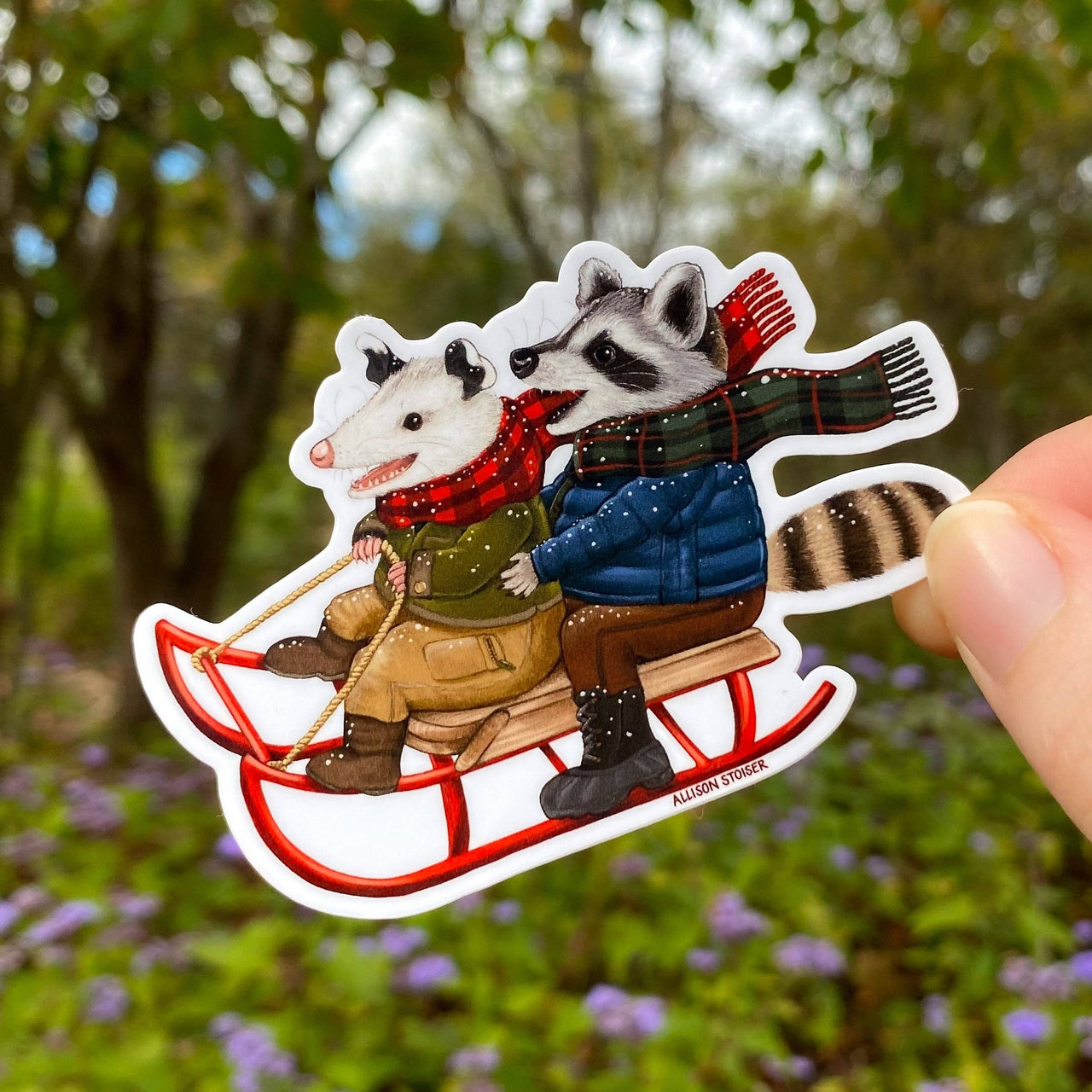 Sledding Opossum and Raccoon Holiday Weatherproof Vinyl Sticker